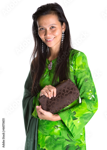 Photo: Asian Malay woman in a green dress with a brown purse Asian Malay woman in a green dress with a brown purse