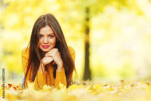 Photo: Girl laying on autumn leafs Girl laying on autumn leafs