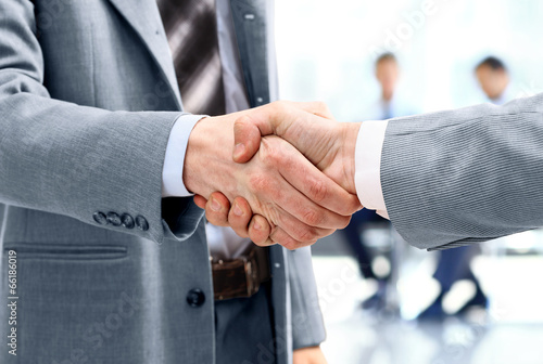 Photo: Close up of businessmen shaking hands Close up of businessmen shaking hands
