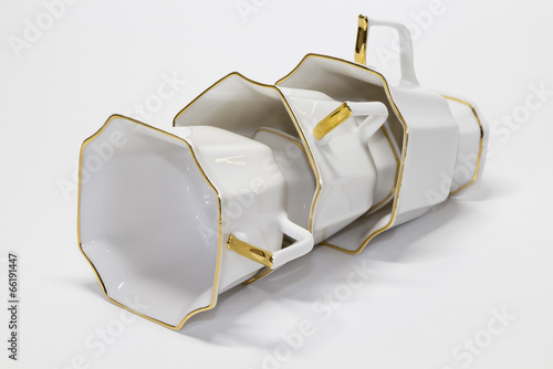 Photo: Three porcelain coffee cups lying in a row Three porcelain coffee cups lying in a row
