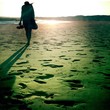 Silhouette of girl walking on the beach Silhouette of girl walking on the beach