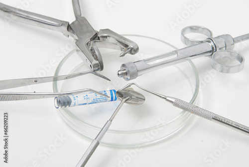 Photo: Metallic dentist tools close up in a dentist clinic. Metallic dentist tools close up in a dentist clinic.