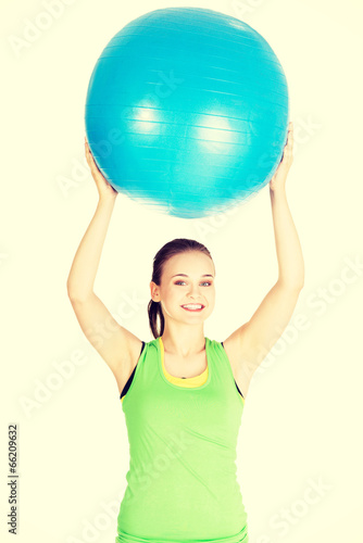 Photo: Woman with pilates exercise ball. Woman with pilates exercise ball.