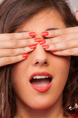 Photo: Sexy girl covering her eyes with her hands Sexy girl covering her eyes with her hands