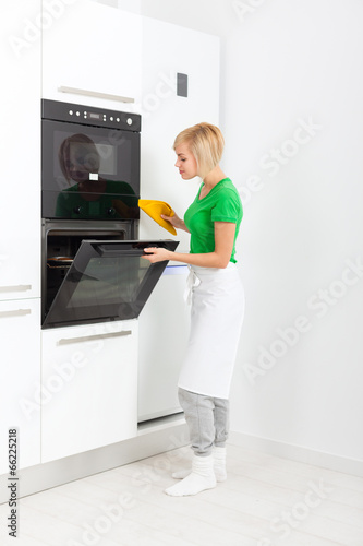 Photo: woman modern kitchen appliance setting woman modern kitchen appliance setting