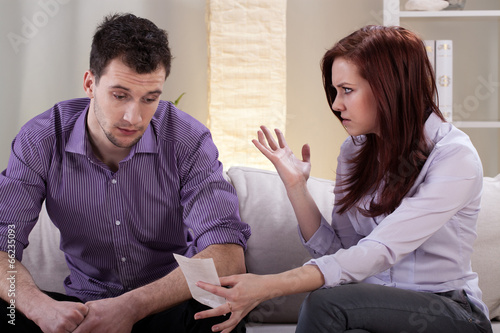 Photo: Angry wife showing bills Angry wife showing bills