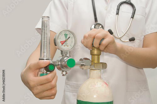Photo: doctor is setting oxygen valve doctor is setting oxygen valve