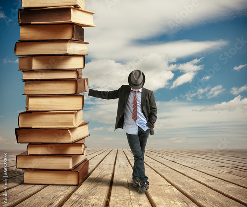 Photo: Man leaning books Man leaning books