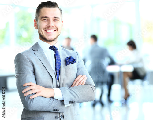 Photo: Businessman with colleagues in the background Businessman with colleagues in the background