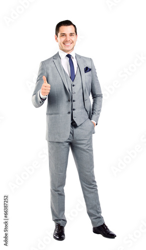 Photo: Businessman showing OK sign with his thumb up. Businessman showing OK sign with his thumb up.