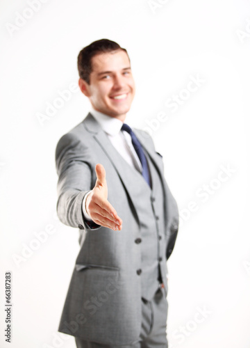 Photo: A business man with an open hand ready to seal a deal A business man with an open hand ready to seal a deal