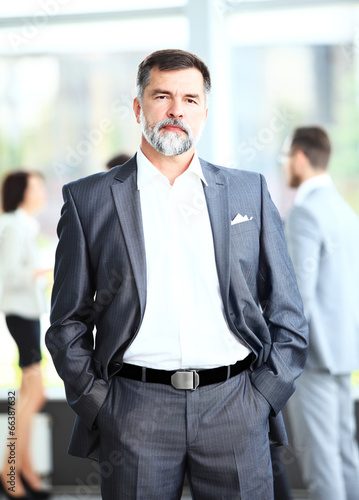 Photo: Portrait of a happy senior business man smiling Portrait of a happy senior business man smiling
