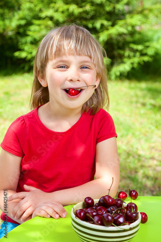 Photo: Child eating wild cherry Child eating wild cherry