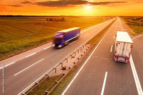 Photo: Blue and white truck in motion blur on the highway Blue and white truck in motion blur on the highway