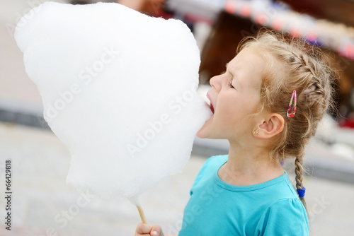 Photo: little girl with cotton candy little girl with cotton candy