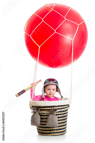 Photo: kid with pilot hat and teleskop on hot air balloon kid with pilot hat and teleskop on hot air balloon