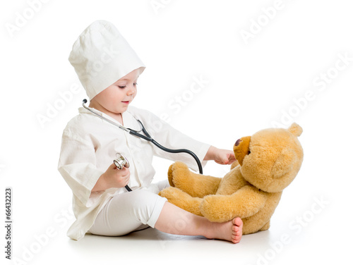 Photo: child girl playing doctor with toy child girl playing doctor with toy