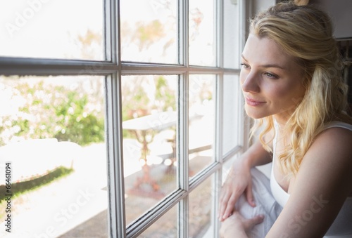 Photo: Pretty blonde looking out the window Pretty blonde looking out the window