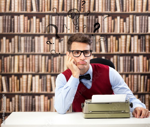 Photo: Old fashioned writer with question marks over head Old fashioned writer with question marks over head