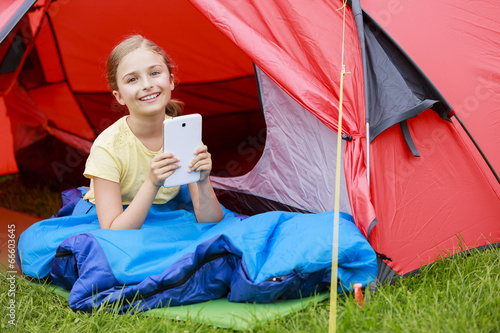Photo: Camp in the tent - young girl on the camping Camp in the tent - young girl on the camping