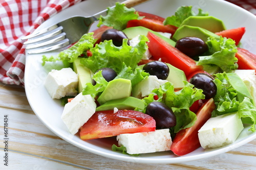Photo: Mediterranean salad with olives, lettuce, cheese and tomatoes Mediterranean salad with olives, lettuce, cheese and tomatoes