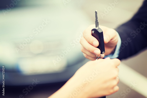 Photo: customer and salesman with car key customer and salesman with car key