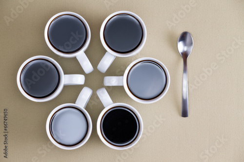 Photo: Decorative design of coffee mugs on beige Decorative design of coffee mugs on beige