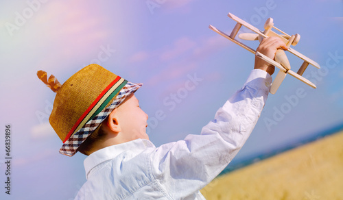 Photo: Young boy playing with a model airplane Young boy playing with a model airplane