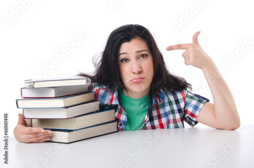Photo: Tired student with textbooks on white Tired student with textbooks on white
