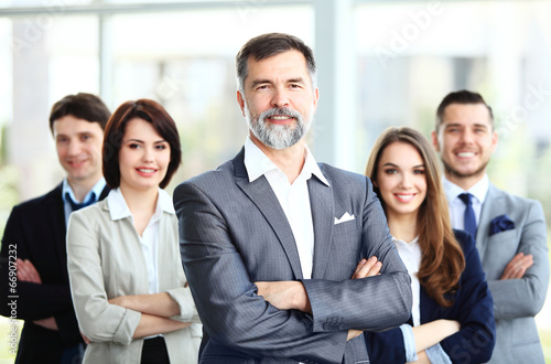 Photo: Happy smiling business team in office Happy smiling business team in office