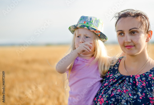 Photo: Mother holding her young daughter on her arm Mother holding her young daughter on her arm