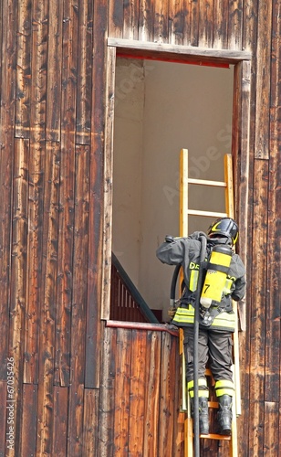 Photo: Firefighter with ladder and the oxygen cylinder Firefighter with ladder and the oxygen cylinder