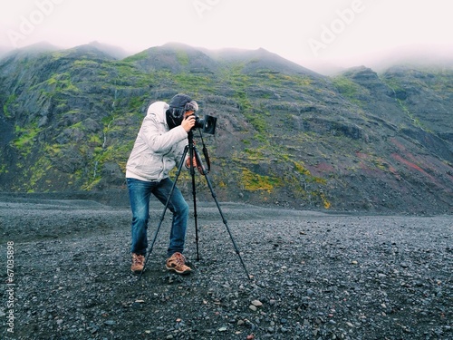 Instant Collection: Photographer with a tripod, in the mountains of Iceland Photographer with a tripod, in the mountains of Iceland