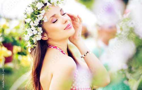 Photo: Pretty brunette lady with the colorful wreath on the head Pretty brunette lady with the colorful wreath on the head