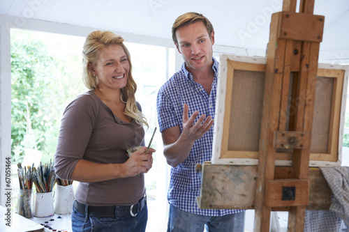 Photo: Woman Attending Painting Class Woman Attending Painting Class