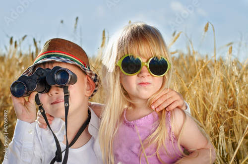 Photo: Two cute little sweethearts playing outdoors Two cute little sweethearts playing outdoors