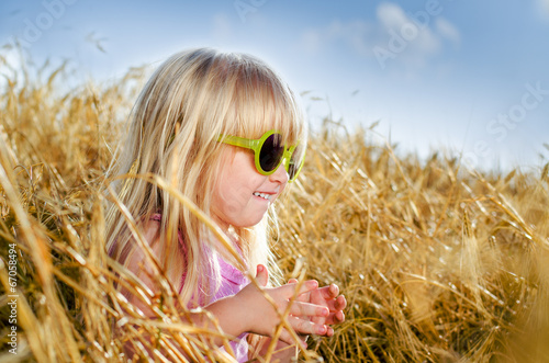 Photo: Pretty little girl in trendy yellow sunglasses Pretty little girl in trendy yellow sunglasses