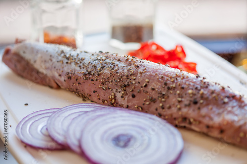 Photo: Raw pork fillet with freshly ground pepper and red onion Raw pork fillet with freshly ground pepper and red onion