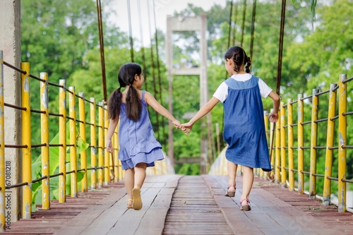Instant Collection: Lovely Asian girls walking together on the bridge Lovely Asian girls walking together on the bridge