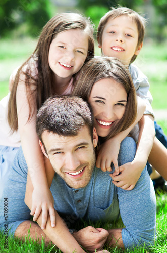 Photo: Family outdoors lying on grass Family outdoors lying on grass