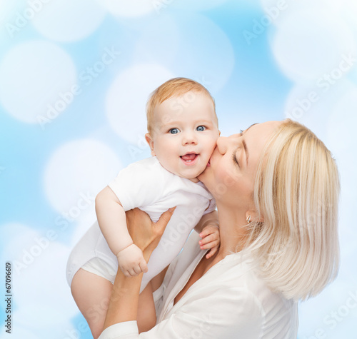 Photo: happy mother kissing smiling baby happy mother kissing smiling baby