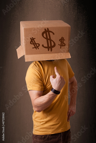 Photo: Young man gesturing with a cardboard box on his head with dollar Young man gesturing with a cardboard box on his head with dollar