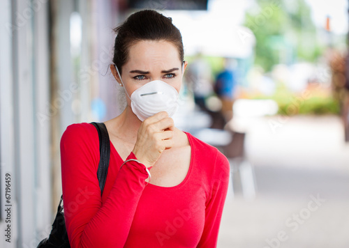 Photo: Woman wearing mask coughing Woman wearing mask coughing