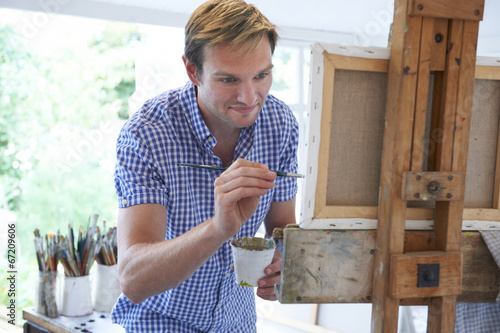 Photo: Male Artist Painting In Studio Male Artist Painting In Studio