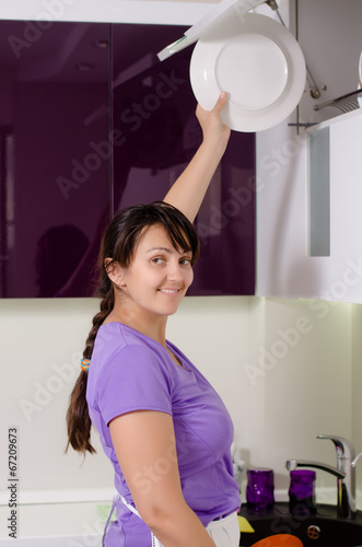 Photo: Attractive housewife doing the dishes Attractive housewife doing the dishes