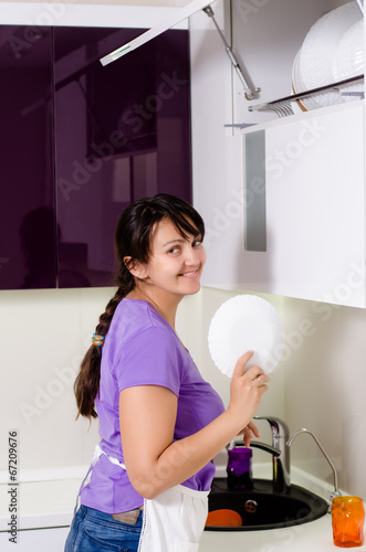 Photo: Attractive housewife doing the dishes Attractive housewife doing the dishes