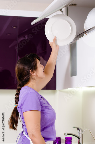 Photo: Attractive housewife doing the dishes Attractive housewife doing the dishes