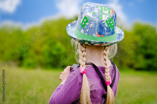 Photo: Small girl in a colorful outfit on a country track Small girl in a colorful outfit on a country track