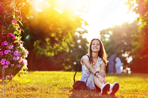 Photo: Beautiful happy smiling girl at the sunset Beautiful happy smiling girl at the sunset