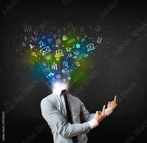 Photo: Business man with glowing media icons exploding head Business man with glowing media icons exploding head